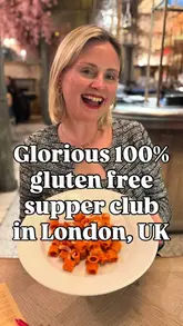 A creator reviews a 100% gluten-free supper club in London, highlighting the atmosphere, the sharing-style menu, and the specific dishes served, including zucchini fries, pasta alla vodka, and pancakes.