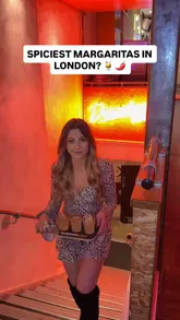A creator visits the newly opened La Familia in Soho, London, to review their spicy margarita flight, which features three levels of heat. The video includes shots of the venue's interior, the bartender preparing the drinks, and the creator tasting the margaritas and food.