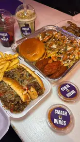 A fast-paced foodie reel showcasing a variety of fast food items including smash burgers, loaded fries, wings, and desserts at Smash N Wings in Northampton, alongside a brief look at the venue's interior.