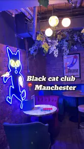 A fast-paced, engaging video showcasing Black Cat Club in Manchester. The reel highlights the venue's interactive games like darts and shuffleboard, alongside a variety of cocktails and food options including burgers, pizzas, and mozzarella sticks. The atmosphere is presented as vibrant and suitable for groups or date nights.