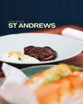A promotional image for a day out in St Andrews, featuring a steak and egg dish at a brunch venue, with a blurred foreground element likely representing a lobster roll.