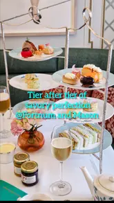 A showcase of the savory afternoon tea service at Fortnum & Mason's Diamond Jubilee Tea Salon, featuring close-ups of savory pastries, sandwiches, and tea service.
