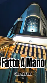 A review of Fatto a Mano pizzeria, focusing on their controversial pineapple pizza special, 'Bella Disgrazia', which supports a local food charity.