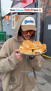 The video features a creator visiting 'Maya Dabeli' in Leicester, UK. The creator reviews several dishes including Dabeli, Amul Cheese Pizza, a 3-in-1 sandwich, Butter Locho, and Khawsa. The video includes shots of the food preparation, the venue's interior, and the creator tasting the food.