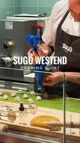 A promotional reel for the opening night of a new Sugo Pasta location in the Westend. The video features a montage of the restaurant's interior, the open kitchen, and a variety of dishes including panzanella, burrata, prosciutto, pasta, tiramisu, and cannoli, set to music with text overlays.