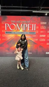 A short video tour of The Last Days of Pompeii immersive exhibition in London, featuring a child exploring the various displays, artifacts, and VR experiences.