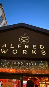 Diners enjoying diverse global cuisines from 15 independent food partners at Alfred Works food hall in Birmingham's Custard Factory.