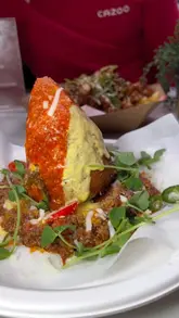 A couple visits Newport Market before a rugby match, showcasing a variety of street food vendors and interactive games like darts. The video highlights the diverse dining options and the fun atmosphere of the market, positioning it as an ideal pre-match destination.