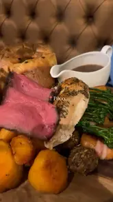 Vegetarian roast dinner with crispy potatoes, colourful vegetables, and rich gravy at Poco Chester in Chester.