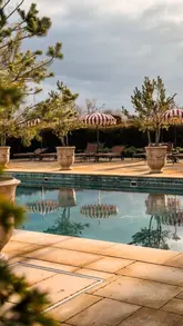 A montage of the exterior and interior of Estelle Manor in Oxfordshire, showcasing the luxury hotel's grounds, pool, and common areas.