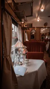 A cinematic tour of the Belmond British Pullman train, highlighting the restored 1920s and 1930s Art Deco interiors, impeccable service, and the fine dining experience while traveling through the countryside.