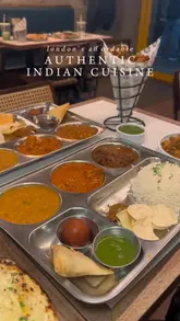 A short, punchy montage showcasing various Indian street food dishes including thalis, samosa chaat, paneer, and onion bhajis at Papa Dum. The video focuses on close-up shots of the food to highlight textures and presentation, ending with a shot of the restaurant exterior.
