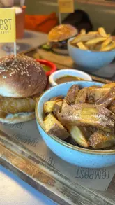 A montage-style video showcasing the interior, drinks, and food menu at Tempest on Tithebarn. The video features various cocktails, nachos, halloumi fries, and burgers, providing a quick overview of the venue's casual dining and bar atmosphere.