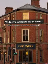 A static exterior shot of a pub and restaurant building taken at dusk, used to set the scene for a spontaneous dining experience.