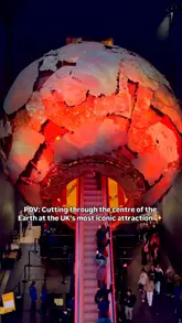 A short, first-person POV video showing the escalator ride through the large, illuminated globe exhibit at the Natural History Museum in London.