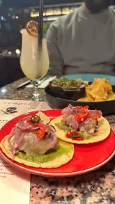 A short, visually focused montage showcasing the food and interior of Temper restaurant in London. The video highlights the open grill, various steak dishes, and their signature tacos, using high-quality, well-lit shots to create an appetizing presentation.