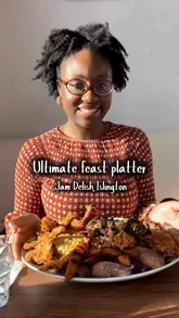 A creator and her mother visit Jam Delish to review their 'ultimate feast platter,' a large, plant-based Caribbean sharing dish. The video features close-ups of the various components of the platter, including jerk skewers, mac and cheese, and plantain, alongside the creator's positive reactions.
