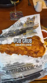 Classic pub grub: golden battered fish with chips at Kennedy's pub in Dublin City Centre.