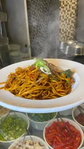 A montage video showcasing the food offerings and live cooking stations at Quayside Buffet. The video features clips of chefs preparing stir-fry and pasta, followed by shots of the extensive buffet spread including pizza, Indian dishes, fried chicken, and a dessert station.