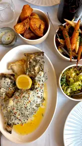 A visually appealing montage showcasing a high-end dining experience at Orion by Alex Webb. The video features a variety of dishes including seafood, a Sunday roast, and an impressive dessert trolley, alongside glimpses of the restaurant's interior and service.