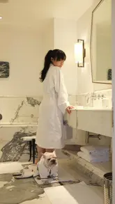 A polished, aesthetic montage documenting a 24-hour stay at Brown's Hotel in London. The video features the creator and her dog enjoying the hotel's amenities, including room service, dining, and the luxurious room interiors.