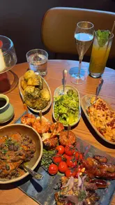 A creator visits Chotto Matte in Manchester to try their Peruvian-inspired Sunday roast, showcasing the venue's interior, a cocktail, and a large sharing platter with various sides.