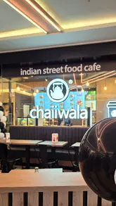 A short, energetic reel showcasing a visit to Chaiiwala in Nottingham's Victoria Centre. The video features a variety of Indian street food dishes, including loaded chips, pani puri, samosa chaat, and a pistachio milk cake, alongside refreshing mocktails. The editing is quick and rhythmic, focusing on the food and drink presentation.