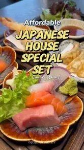 A couple reviews the 'Nagoya Premium House Special Set' at a Japanese restaurant in Canary Wharf, showcasing the variety of dishes included in the set menu and the restaurant's modern interior.