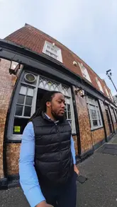 A creator visits Maureen's Pie & Mash in East London to try traditional British pie and mash for the first time, interacting with staff and customers to get recommendations on how to eat it.