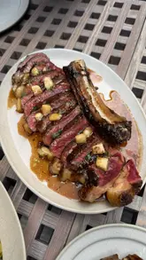 A high-quality showcase of a Spanish-inspired restaurant in London, featuring close-up shots of various dishes including seafood, steak, and desserts. The video highlights the fire-led cooking style and the quality of the ingredients.