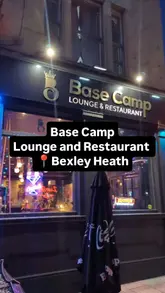 A review of Base Camp Lounge and Restaurant, highlighting its vibrant interior design featuring graffiti and flower walls, as well as its menu of Nepalese and Indian dishes and creative cocktails.