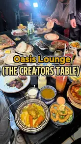 A vlog-style review of Oasis Lounge in North London, featuring a Moroccan-themed dining experience with a group of creators. The video showcases the interior decor, various dishes including calamari and lamb couscous, and the overall social atmosphere.