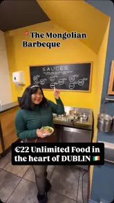 A creator visits The Mongolian Barbeque in Dublin's Temple Bar area, showcasing the all-you-can-eat DIY dining experience. The video guides viewers through the process of selecting ingredients, watching the chef cook them on a large grill, and enjoying the final meal, along with drinks and dessert.