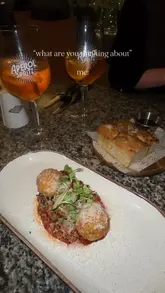 A montage-style video showcasing various Italian dishes and drinks at Topolys, featuring close-ups of pasta, risotto, arancini, and Aperol Spritz, set to music with a simple text overlay.