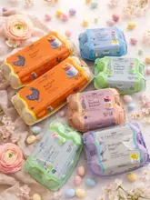 A high-quality, aesthetically pleasing flat lay photograph featuring various cartons of Clarence Court eggs arranged on a light-colored surface decorated with flowers and small decorative eggs, evoking a spring/Easter theme.