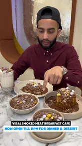 A creator reviews a restaurant in Walthamstow, highlighting their new dinner menu and dessert offerings. The video features close-ups of various dishes including smoked meat platters, fish, French toast, and cookie dough, with the creator providing commentary on the taste and quality.