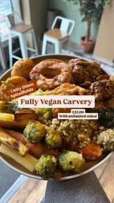 A creator visits Unity Diner in London to review their plant-based Sunday carvery, highlighting the variety of vegan roasts and unlimited sides available for a fixed price.