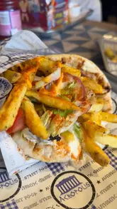 A short, punchy video showcasing Greek street food, specifically gyros and a kids' meal box, filmed at a shopping centre location.