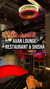 A creator visits Avan Lounge & Bar to review their African cuisine, cocktails, and overall atmosphere. The video features a tour of the venue, including the dining area, games room, and shisha lounge, while highlighting specific dishes like jollof rice and plantain.