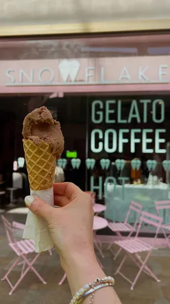 A hand holds a scoop of creamy corn-flavoured gelato from Snowflake Gelato in Oxford.