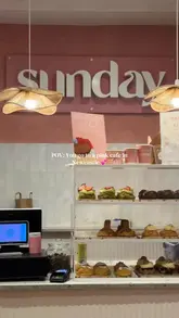 A short, aesthetic montage showcasing the interior and menu items of a pink-themed cafe in Newcastle, featuring matcha drinks and cookies.