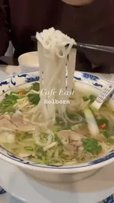 A montage of various Vietnamese dishes served at Cafe East in Holborn, featuring close-ups of pho, summer rolls, and grilled squid. The video relies on static, well-lit shots of the food being prepared or served, with text overlays identifying the venue.