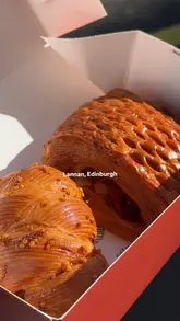 A short, high-quality montage showcasing the exterior, queue, and pastry selection at Lannan Bakery in Edinburgh, highlighting the variety and quality of the baked goods.