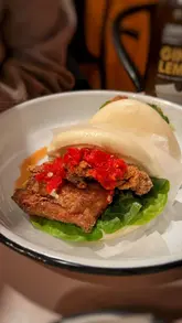 A short, visually focused reel showcasing various bao buns, seaweed fries, and a salad from Yum Bun at Seven Dials Market.