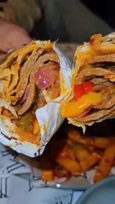 A montage video showcasing the food, shisha, and atmosphere at Majlis Lounge in Leicester, featuring shots of a doner wrap, masala chips, chicken shawarma, mozzarella sticks, and a milkshake.