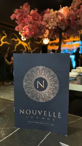 A montage video showcasing the interior, cocktails, and various Indian dishes at Nouvelle Lounge, featuring smooth camera work and professional lighting.