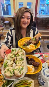 A creator visits the newly opened Yeye noodle and dumpling restaurant in Soho, London. The video features a tour of the interior, a look at the kitchen staff preparing food, and a review of various dishes including noodles, dumplings, and a sharing platter.