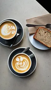 A montage-style video showcasing the interior, coffee, and baked goods of a cafe in Edinburgh. The video uses slow, steady shots to highlight the minimalist decor, the espresso machine, and the coffee service, creating a calm and inviting mood.