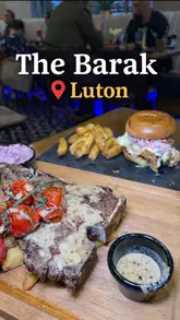 A montage video showcasing the interior, cocktails, and various dishes at The Barak, a new restaurant in Luton. The video features close-ups of food preparation and presentation, including beef marrow, chicken wings, steak, and a burger.