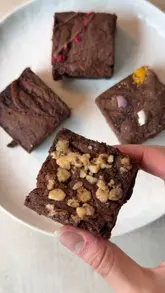 A short, visual product showcase featuring an unboxing of a box of gluten-free brownies from Brownie Alchemy, highlighting the different flavours and textures.